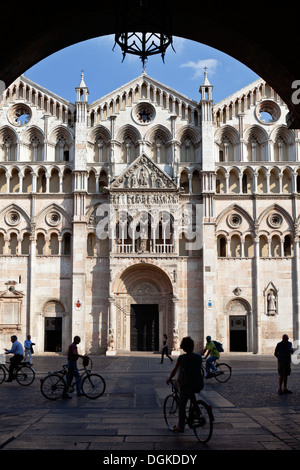 Cyclists in the Piazza Cattedrale outside the Cathedral in Ferrara. Stock Photo