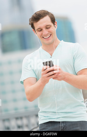 Man listening to music on smartphone Stock Photo