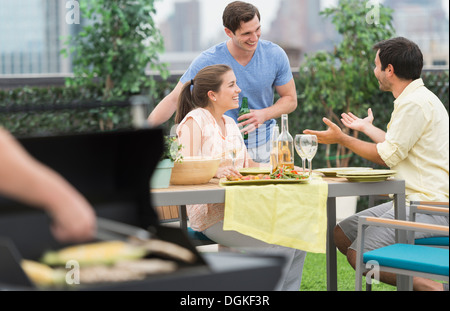 Friends enjoying barbecue in garden Stock Photo