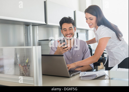 Business man and woman at work in office Stock Photo