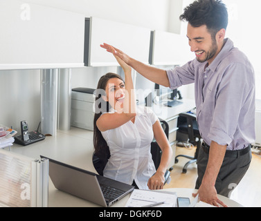 Woman and man giving high five to each other Stock Photo