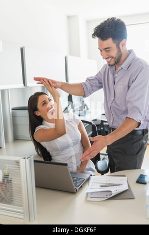Woman and man giving high five to each other Stock Photo