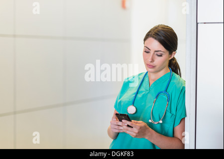 Female doctor text messaging Stock Photo