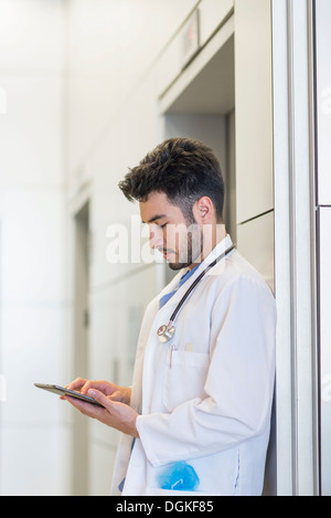 Doctor using digital tablet in hospital Stock Photo