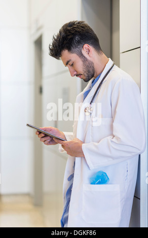 Doctor using digital tablet in hospital Stock Photo