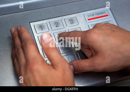 Insert PIN Code, Finger pressing password number on ATM machine Stock Photo