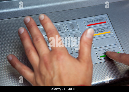 Finger pressing password number on ATM machine, Insert PIN Code Stock Photo