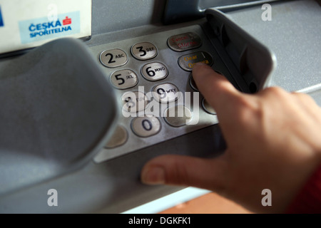 Insert PIN Code, Finger pressing password number on ATM machine Stock Photo