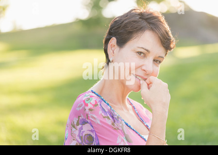 Portrait of mature woman smiling outdoors Stock Photo