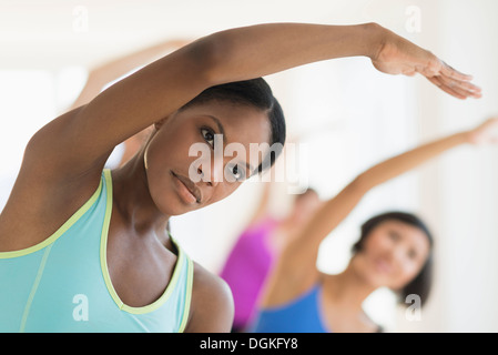 People stretching in gym Stock Photo