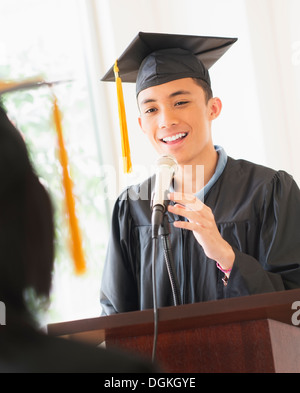 Young man giving speech at graduation Stock Photo