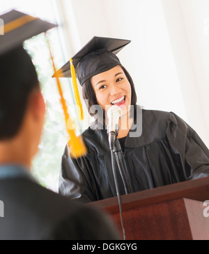 Young woman giving speech at graduation Stock Photo