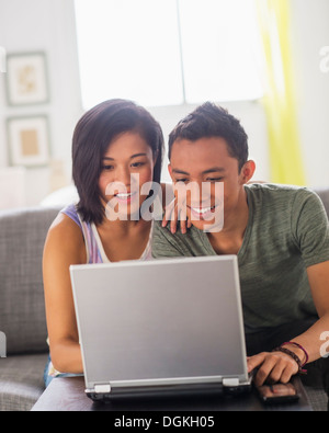 Young woman and young man using laptop Stock Photo