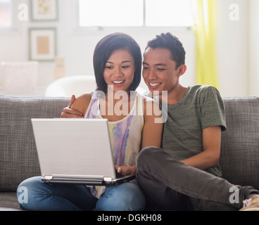 Young woman and young man using laptop Stock Photo