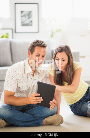 Portrait of couple using digital tablet Stock Photo