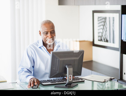 Portrait of senior man working on computer in office Stock Photo