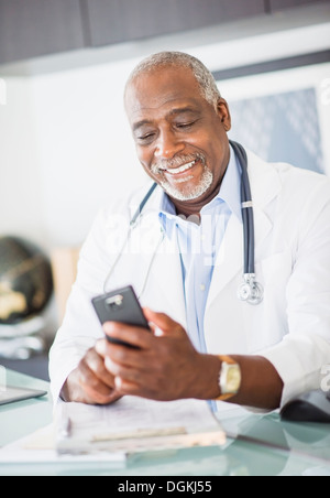 Portrait of doctor text messaging Stock Photo