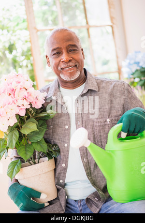 Portrait of man working in greenhouse Stock Photo