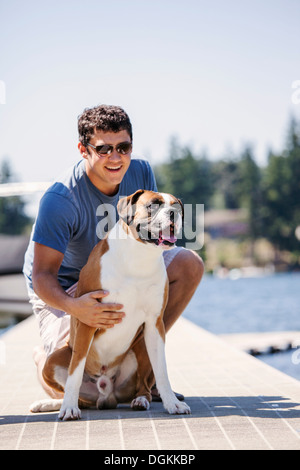 USA, Washington, Bellingham, Portrait of young man posing with his dog Stock Photo