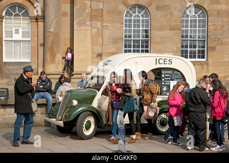 People buying ice cream from a retro van. Stock Photo