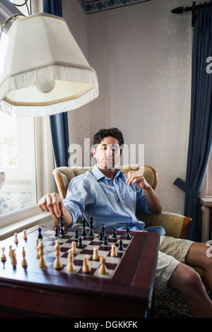 Portrait of young man playing chess Stock Photo