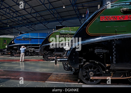 A man photographing one of the A4 Pacific steam locomotives at the National Railway Museum. Stock Photo