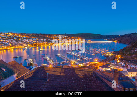 Boats moored on the river Dart with Dartmouth in the background. Stock Photo