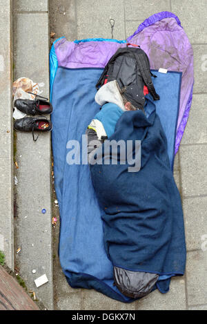 Homeless man sleeping on the ground, Hamburg, Hamburg, Germany Stock Photo