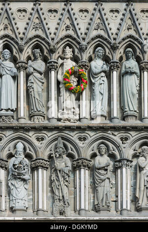 West facade on Nidaros Cathedral in Trondheim, detail with statues of saints, King Olaf II Haraldsson is decorated with a wreath Stock Photo