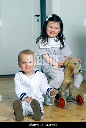 Siblings, boy, 2, and girl, 5, wearing sailor outfits Stock Photo