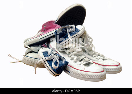 Sneakers or trainers of a whole family gathered in one heap Stock Photo