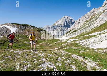 Man and a woman while hiking, climbing from Vodnikov dom refuge to Triglav, Triglav National Park, Slovenia, Europe Stock Photo