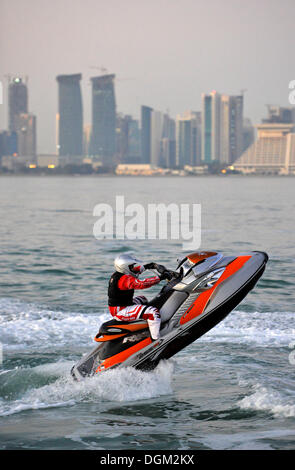 Jet-skiing, jetboat, personal watercraft in front of the skyline of Doha, Qatar, Persian Gulf, Middle East, Asia Stock Photo