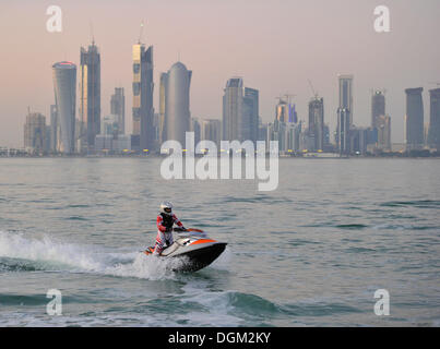 Jet-skiing, jetboat, personal watercraft in front of the skyline of Doha, Qatar, Persian Gulf, Middle East, Asia Stock Photo