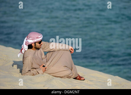 Arab in front of Khor Al Udeid Beach, Khor El Deid, Inland Sea, desert miracle of Qatar, Emirate of Qatar, Persian Gulf Stock Photo