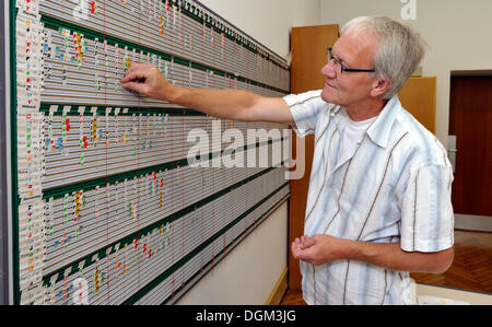 Teacher working on scheduling board for timetable, manpower planning Stock Photo