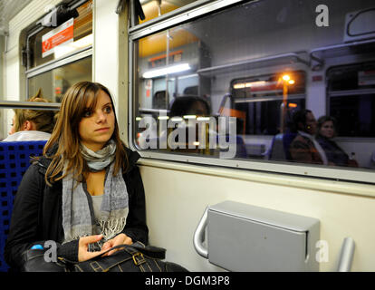 Young woman on suburban train, Stuttgart, Baden-Wuerttemberg Stock Photo