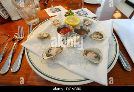 Oysters and dips on a plate in a restaurant Stock Photo