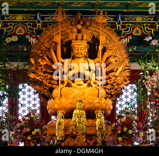 Thousand hands wooden Buddha in Chinese temple,Thailand Stock Photo