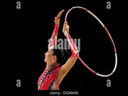 Woman, gymnastics and hoop for performance, sports training and dancing  action in arena. Female, rhythmic movement and dancer with spinning ring  for Stock Photo - Alamy