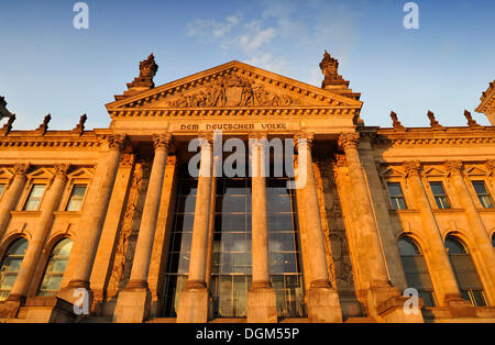 Evening light on the Reichstag German Parliament, words 'Dem Deutschen Volke' or 'To the German People' and relief in the Stock Photo