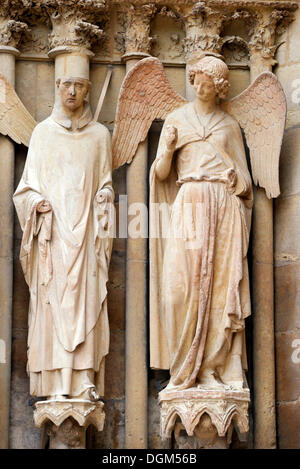 Statues, on the right the 'friendly angel', left portal, west façade, Cathedral of Notre-Dame, Unesco World Heritage Site Stock Photo