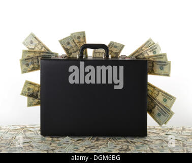 Briefcase, suitcase full of money, dollar bills Stock Photo