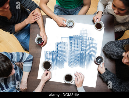 Overhead view of people sitting around table Stock Photo