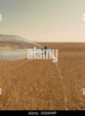 The landscape of the Black Rock Desert in Nevada. A bottle of water being poured out. Filtered mineral water. Stock Photo