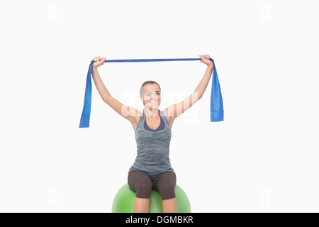 Pretty woman training sitting on fitness ball Stock Photo