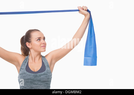 Ponytailed young woman training using a resistance band Stock Photo