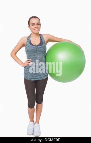 Cute young woman holding a fitness ball Stock Photo