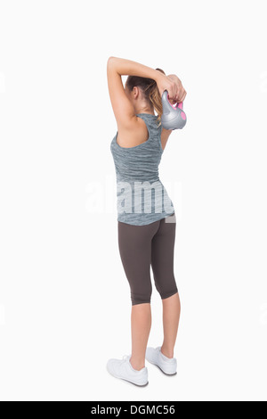 Rear view of woman working with kettle bell Stock Photo