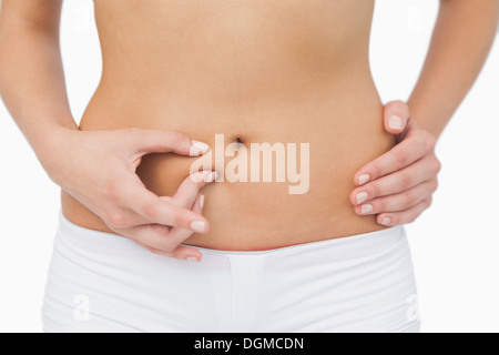 Young woman without any fat on her belly Stock Photo